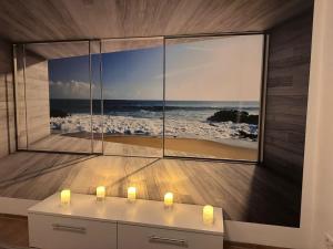 a room with a large picture of the beach at NEU! Kleines Glück Illingen in Illingen