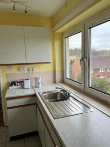 a kitchen with a sink and a window at Budget Central Birmingham in Birmingham
