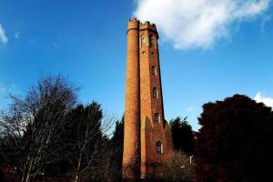 a tall brick tower with a clock on it at Budget Central Birmingham in Birmingham +16 photos