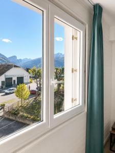 a window with a view of the mountains at Le Napoléon in Corps
