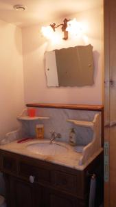 a bathroom with a sink and a mirror at Gites laurent in Guissény +24 photos