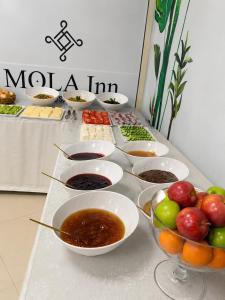 a buffet with bowls of food on a table at Mola INN Uşak in Uşak +13 photos