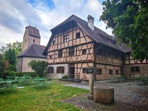 a large wooden building with a tower and a church at Hostel Feldkirch in Feldkirch