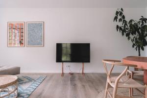 a living room with a flat screen tv on a wall at Apartment Søglas in Gmund am Tegernsee