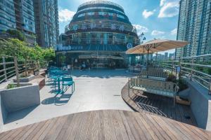 a building with benches and tables in a city at F18 Hub Youth Hostel in Chengdu
