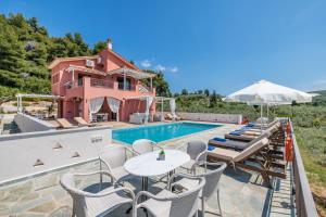 a villa with a swimming pool and a house at Luxury Villa with Private Pool in Skopelos, Spacious & Private, Villa Amaryllis By Kardous in Alikias