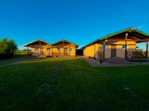 a couple of buildings with a grass yard at Domkiuweroniki in Mielenko