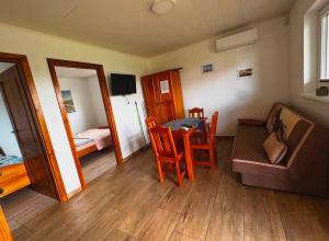 a room with a table and chairs and a bedroom at Domkiuweroniki in Mielenko