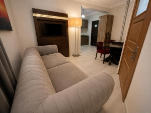 a living room with a couch and a table at Mola INN Uşak in Uşak
