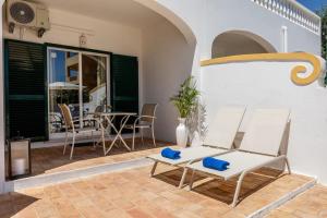 a patio with two chairs and a table at Luz Sun Poolhouse in Luz