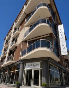 a building with a sign in front of it at Mola INN Uşak in Uşak