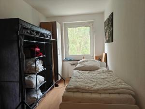a bedroom with a bed and a window at 3-room vacationapartm Sax Switzerland very basic in Lauterbach