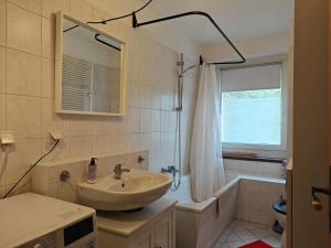 a bathroom with a sink and a bath tub and a sink at 3-room vacationapartm Sax Switzerland very basic in Lauterbach