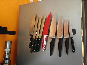 a group of knives hanging on a wall at 3-room vacationapartm Sax Switzerland very basic in Lauterbach +11 photos