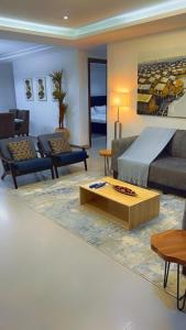 a living room with a bed and a coffee table at The Abode in Lekki Phase 1
