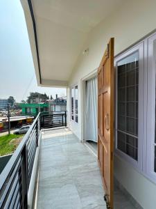 a balcony of a house with a view of the water at Tre Lum Homestay in Jowai +7 photos