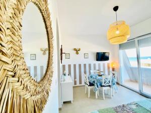 a dining room with a mirror and a table at Vear Hausing - Piramidi 17 in Lido delle Nazioni