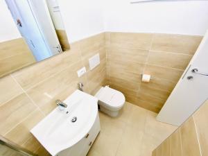 a bathroom with a white sink and a toilet at Vear Hausing - Piramidi 17 in Lido delle Nazioni +14 photos