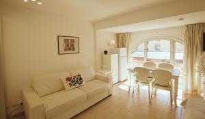 a living room with a couch and a table at Le Studio des Deux Frontières in Beausoleil