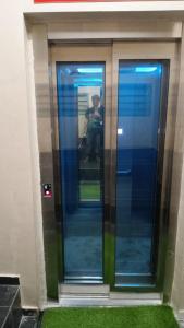 a person sitting in an elevator in a building at Qish Hotel Melaka in Malacca