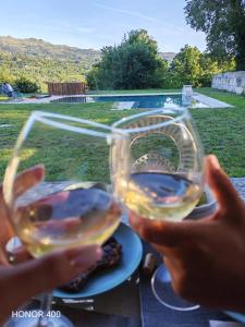 two people holding up glasses of white wine at Retiro Maria Idalina in Amarante