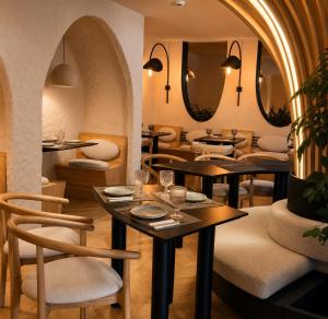 ein Restaurant mit Tischen, Stühlen und Spiegeln in der Unterkunft Garden Retreat in Bran