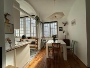 a kitchen and dining room with a table and chairs at Cosy Néroli - T3 - Parking privée plein centre ville in Pau