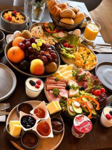 a table with many plates of food on it at Hotel Weinhaus Wiedemann in Ginsheim +6 photos
