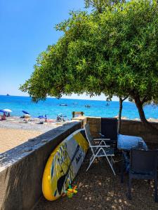 a surfboard leaned against a wall on a beach at W beach house in Buljarica