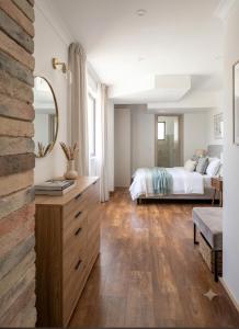 a bedroom with a bed and a mirror at W beach house in Buljarica