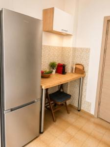 a stainless steel refrigerator in a kitchen with a wooden table at W beach house in Buljarica