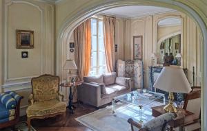 a living room with a couch and a chair at Lovely Home In Clef Vallée D'eure in La Croix-Saint-Leufroy