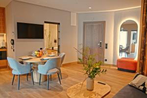a living room with a table and chairs at Fomich Estates in Bukovel