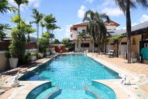 a swimming pool in a villa with a resort at Chalong Pool Courtyard in Ban Na Bon