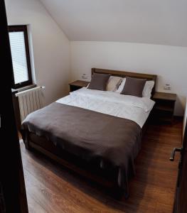 a bedroom with a large bed and a window at Casa Om Bun in Beclean +16 photos
