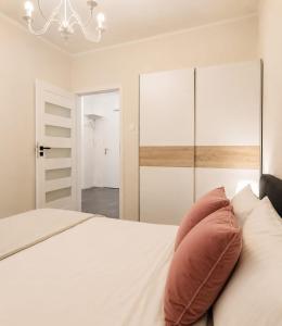 a bedroom with a bed with a pillow on it at JBHotels Apartament DeLuxe przy Galaxy in Szczecin