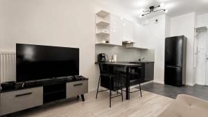 a kitchen with a black table and a black refrigerator at JBHotels Apartament DeLuxe przy Galaxy in Szczecin