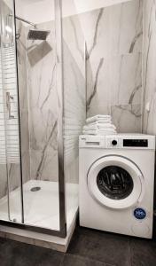 a washing machine in a bathroom with a shower at JBHotels Apartament DeLuxe przy Galaxy in Szczecin +11 photos