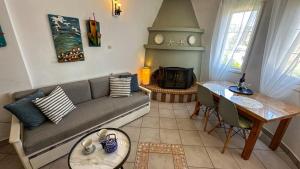 a living room with a couch and a fireplace at Katias Villa in Alonnisos