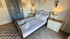a bedroom with a bed with towels on it at Katias Villa in Alonnisos +17 photos