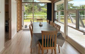 a dining room with a table and chairs and windows at Awesome Home In Gørlev With Wifi in Gørlev