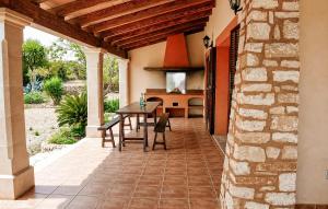 an outdoor patio with a table and a kitchen at Sa Tanqueta De Calonge in Santanyi +14 photos