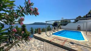 a villa with a swimming pool and a view of the water at Katias Villa in Alonnisos