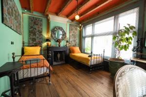 a bedroom with a bed and a fireplace and a mirror at Royal Suites - Salon de Franz in Amsterdam