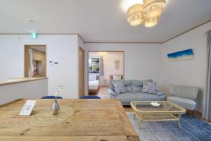 a living room with a table and a couch at 北谷町港1 in Chatan