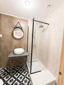 a bathroom with a glass shower and a sink at Le Napoléon in Corps +5 photos