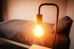 a light that is next to a bed at Karoo 62 Bush Motel in Ladismith