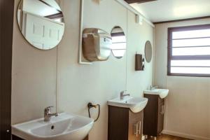 a bathroom with two sinks and a mirror at Karoo 62 Bush Motel in Ladismith