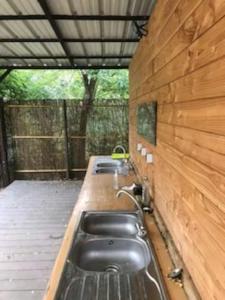 a row of sinks in a wooden building at Domaine de Montaut in Montaut-Ariège