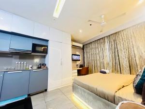 a hotel room with a bed and a kitchen at Supernova luxe heaven in New Delhi